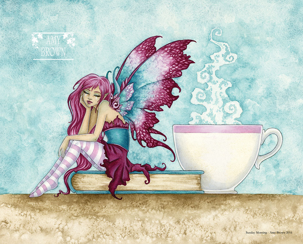 A fairy sits on a book next to a steaming cup of tea or coffee. 