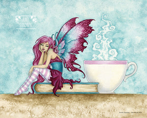 A fairy sits on a book next to a steaming cup of tea or coffee. 
